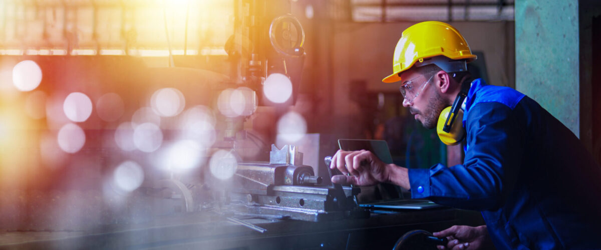 Professional industrial engineer, technician, factory worker wear hard hat, safety glasses. While checking, set up, control machine heavy industry factory. Employee working in manufacturing facility.